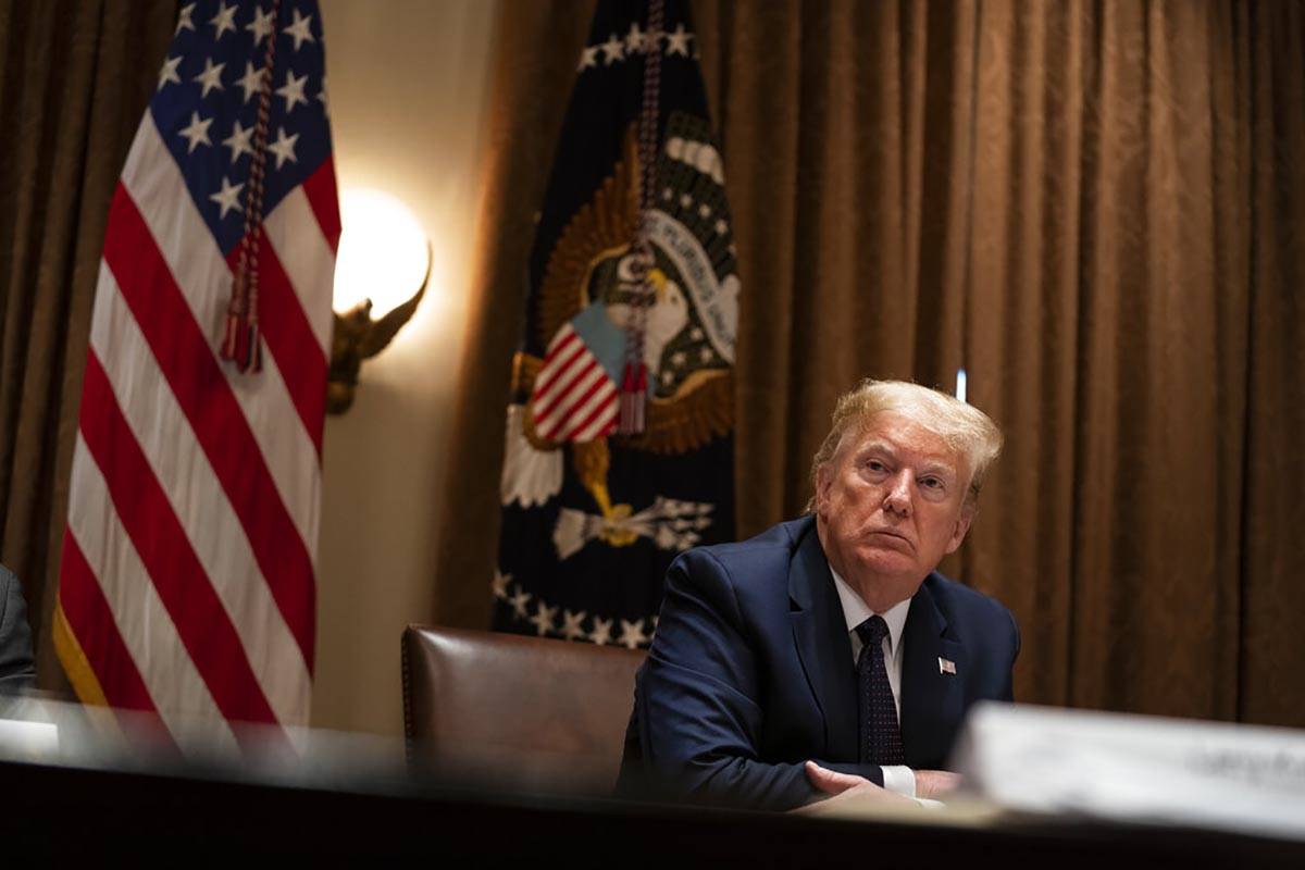 President Donald Trump listens during a meeting on opportunity zones in the Cabinet Room of the ...