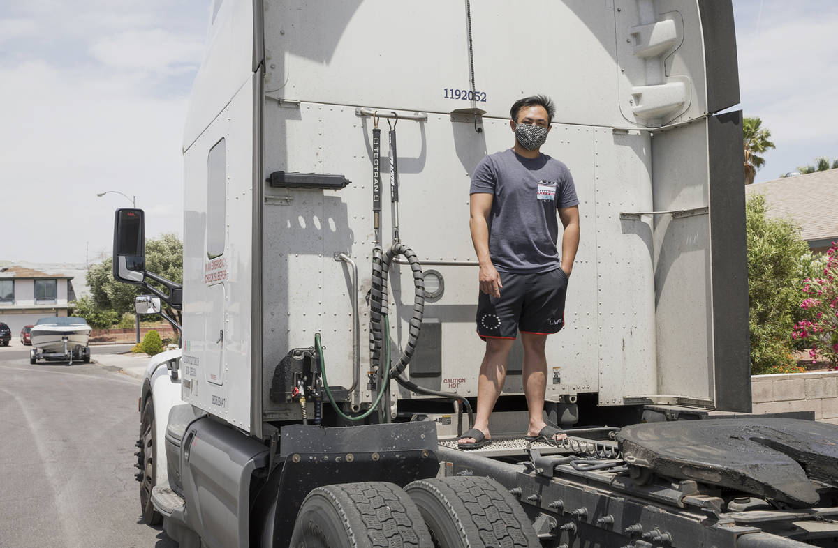 Kim Santiago, an over-the-road truck driver, outside his truck at his home in Las Vegas on Sund ...