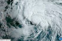 In this satellite image made available by NOAA shows Tropical Storm Arthur off the coast of Nor ...