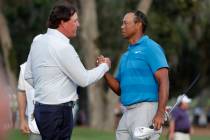 In this May 10, 2018, file photo, Phil Mickelson, left, and Tiger Woods shake hands after the f ...