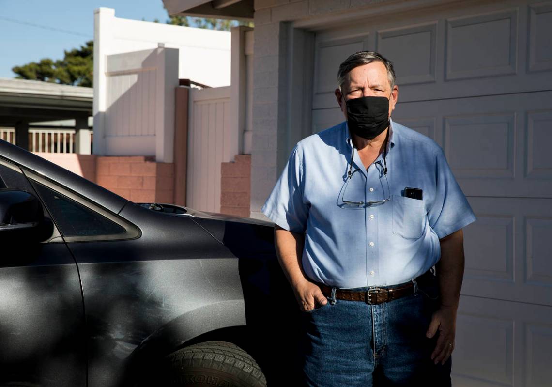 David Shapin, normally a full-time Uber and Lyft driver, next to his car at his home in Las Veg ...