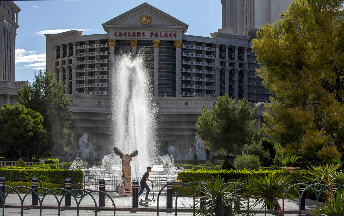 A scooter rider moves past the main Caesars Palace fountain area now back in operation on Monda ...