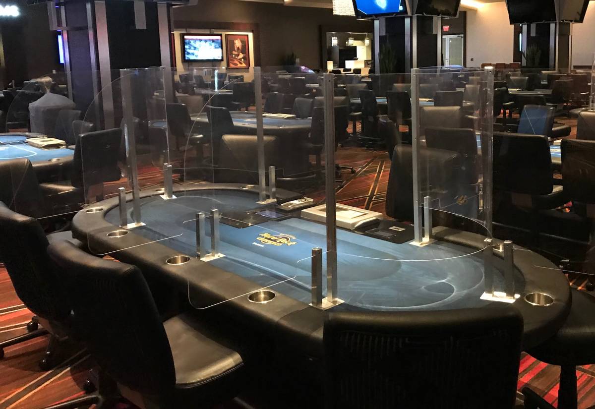 Poker tables with plexiglass dividers are being used at the Seminole Hard Rock casino in Tampa, ...