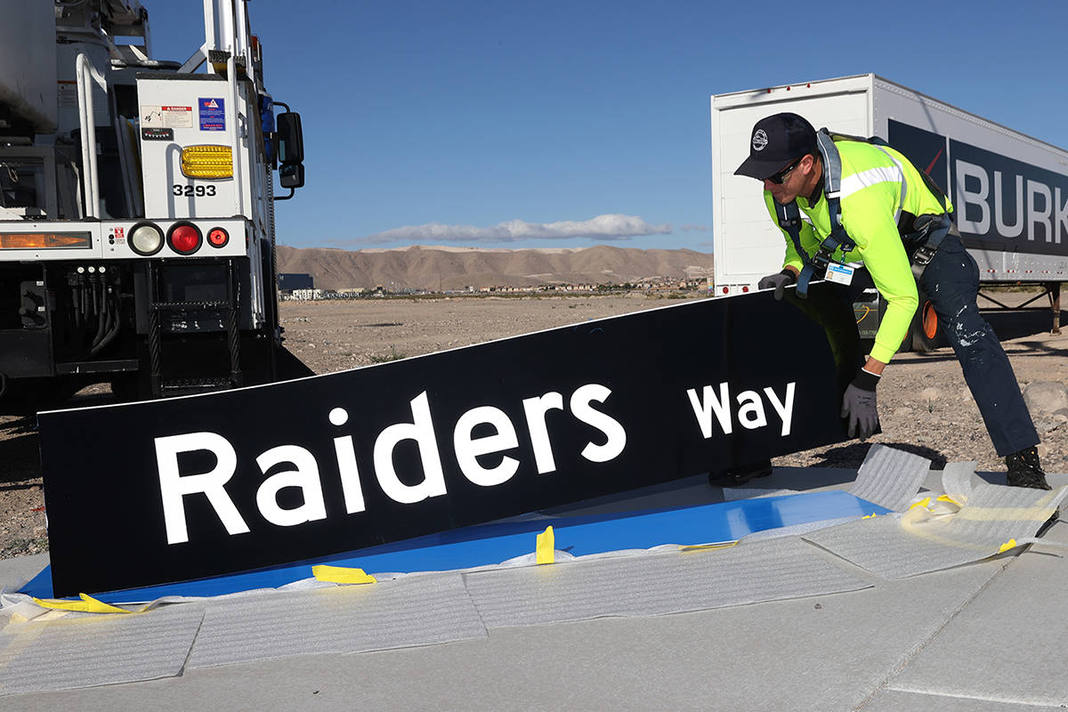 Justin Buhl, traffic signal technical for the City of Henderson, gets ready to install a Raider ...