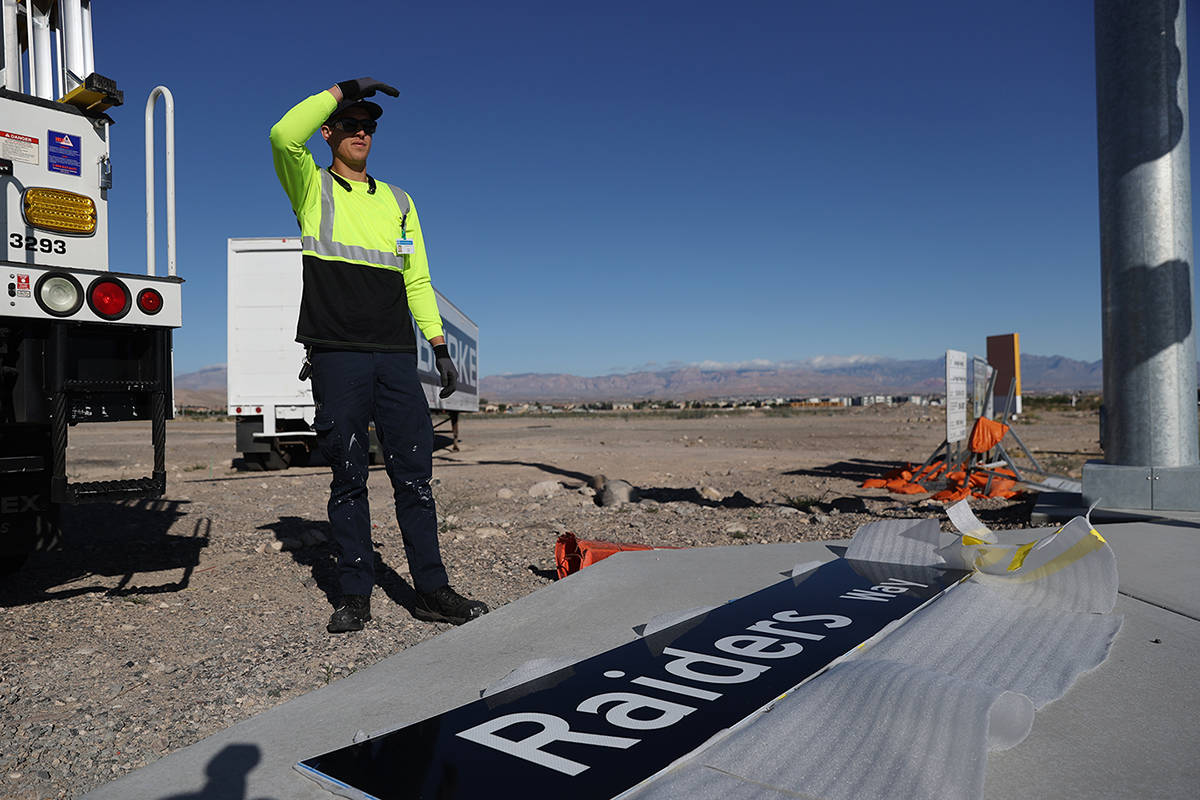 Justin Buhl, traffic signal technical for the City of Henderson, gets ready to install a Raider ...