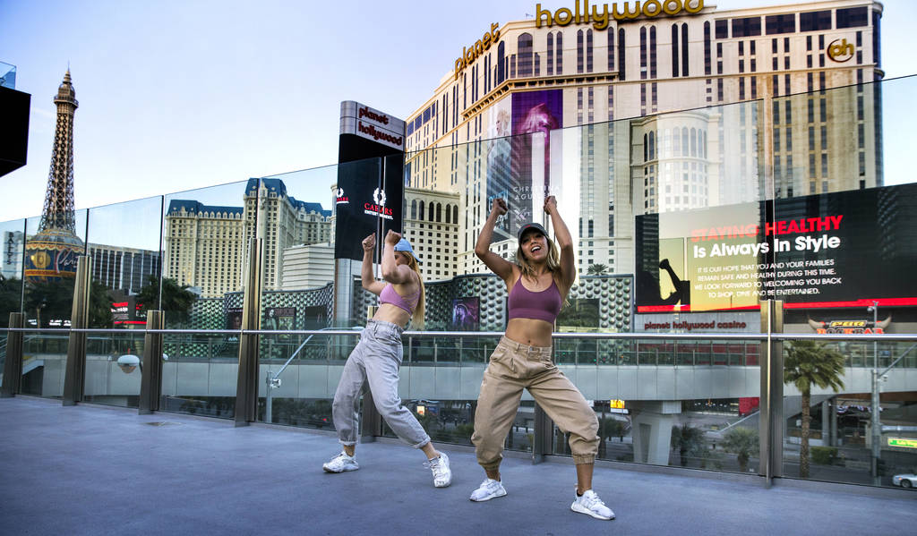 Carolyn Oliver, left, and Lisa Love practice a dance routine on a pedestrian bridge near the Co ...