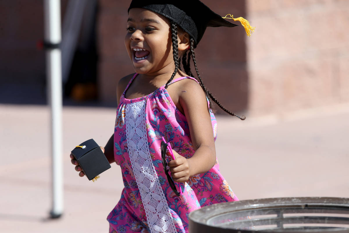 Cali Smith, 4, with her grad gift during a drive-thru graduation for preschoolers at SkyView YM ...