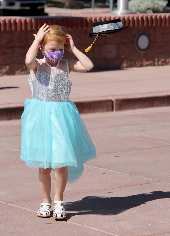 Allysandra Millmine, 4, loses her cap during drive-thru graduation for preschoolers at SkyView ...