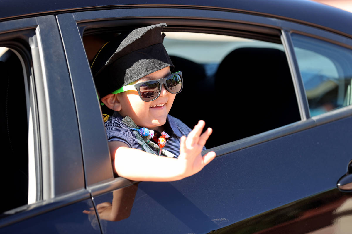 Julian Acosta, 4, drive-thru graduation for preschoolers at SkyView YMCA in Las Vegas Tuesday, ...