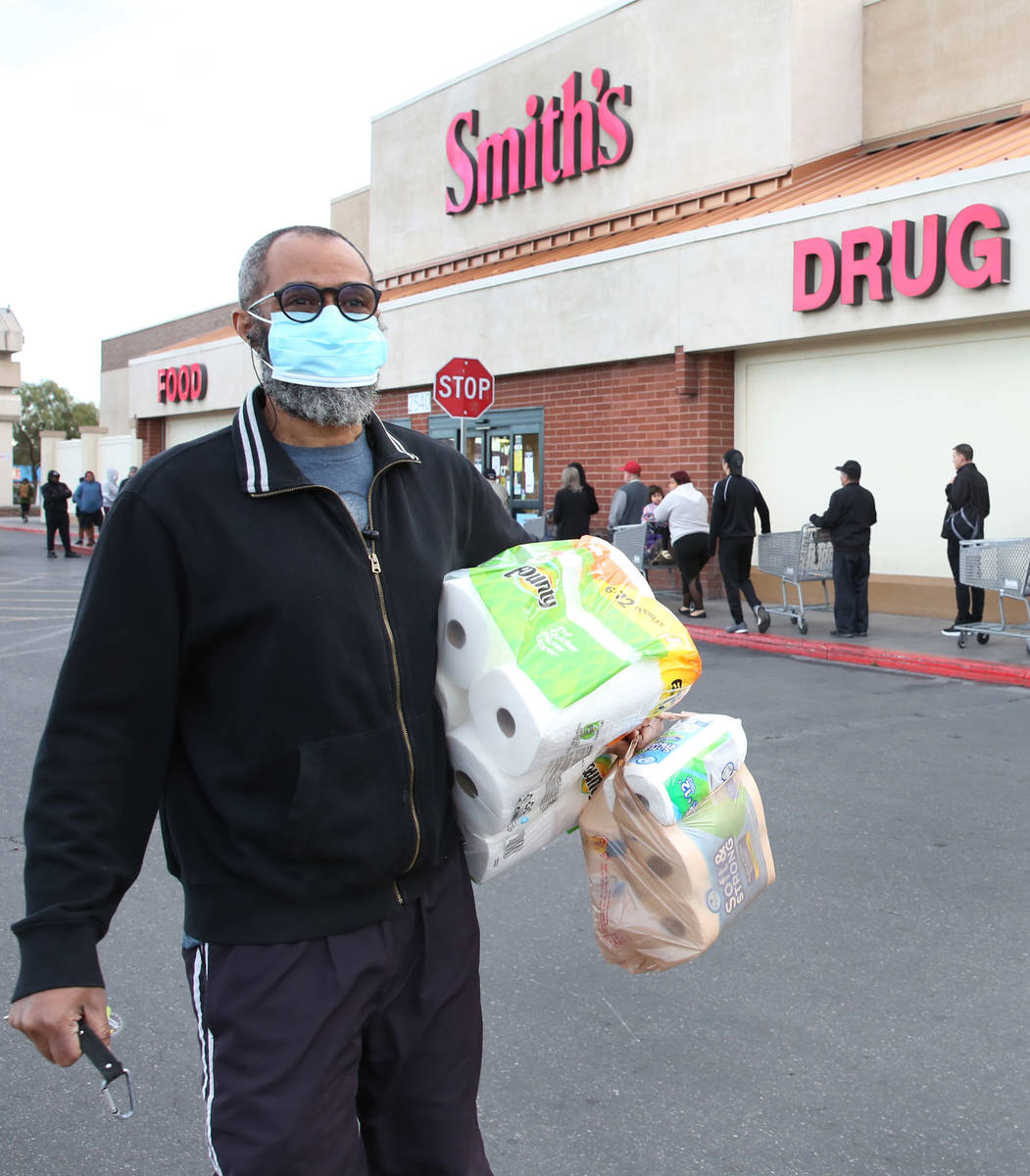 Terrance Brown carries toilet papers after shopping at a Smith's store on Maryland Parkway on W ...