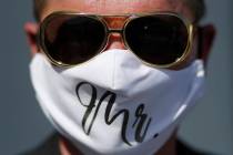 Vaughan Chambers wears a mask after marrying Alicia Funk at A Little Wedding Chapel, Tuesday, M ...