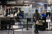 Passengers stop by a Transportation Security Administration checkpoint at McCarran Internationa ...