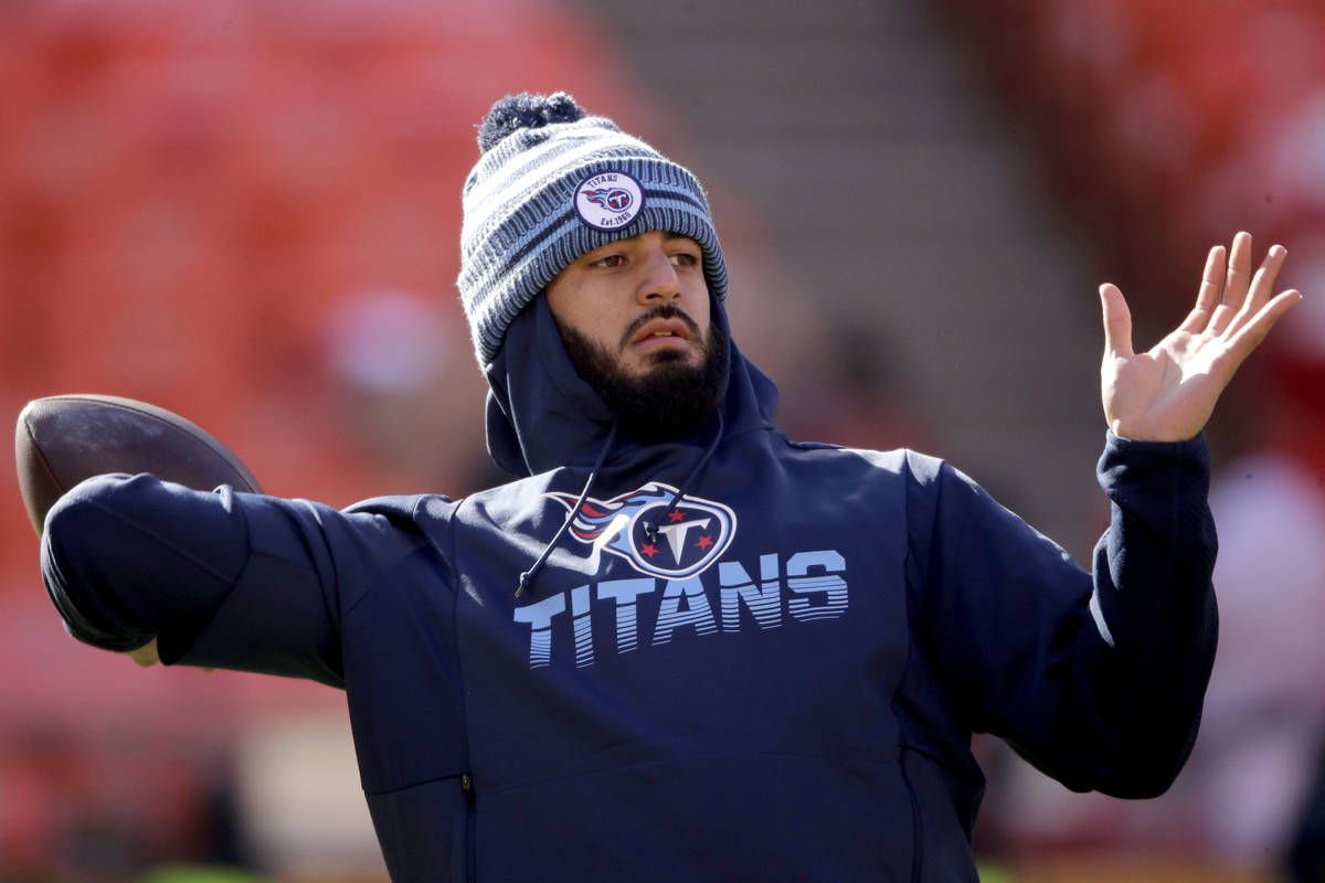 In this Jan. 19, 2020, file photo, Tennessee Titans' quarterback Marcus Mariota warms up before ...
