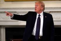 President Donald Trump gestures as he leaves after a meeting with restaurant industry executive ...