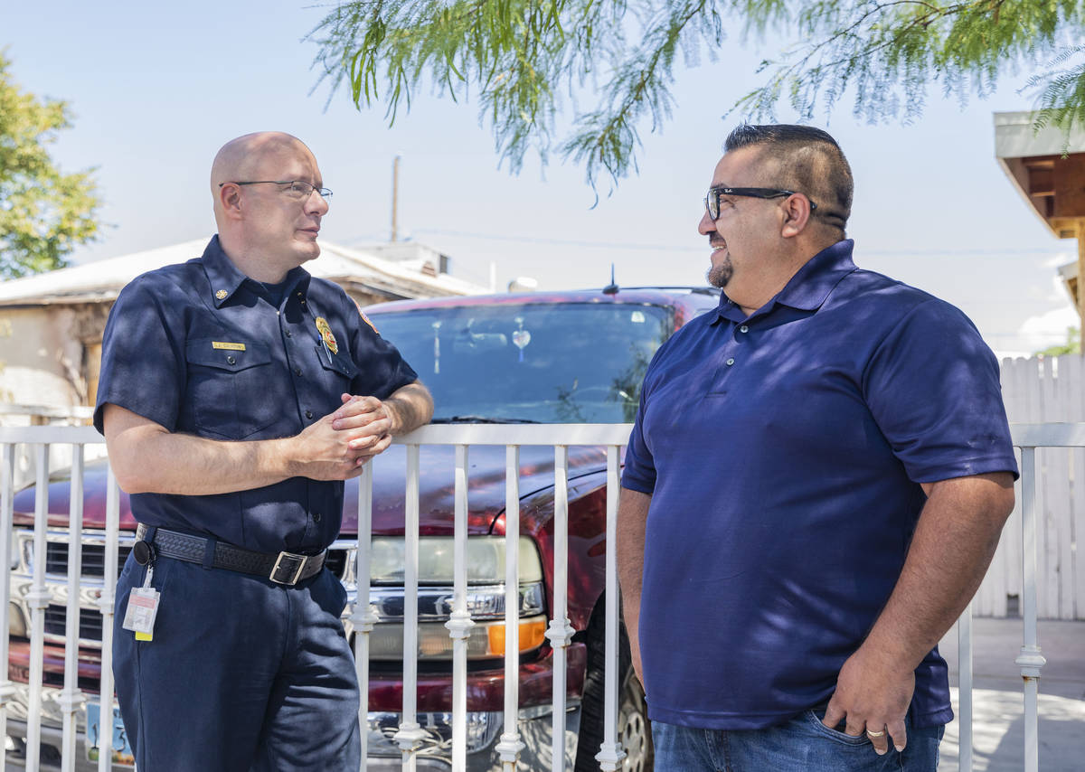 North Las Vegas Fire Chief Joseph Calhoun congratulates Jose Alvarado on Wednesday, May 20, 202 ...