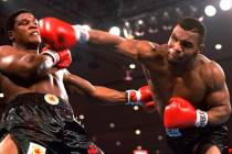 In this Nov. 22, 1986, file photo, Mike Tyson, right, delivers a blow to Trevor Berbick during ...