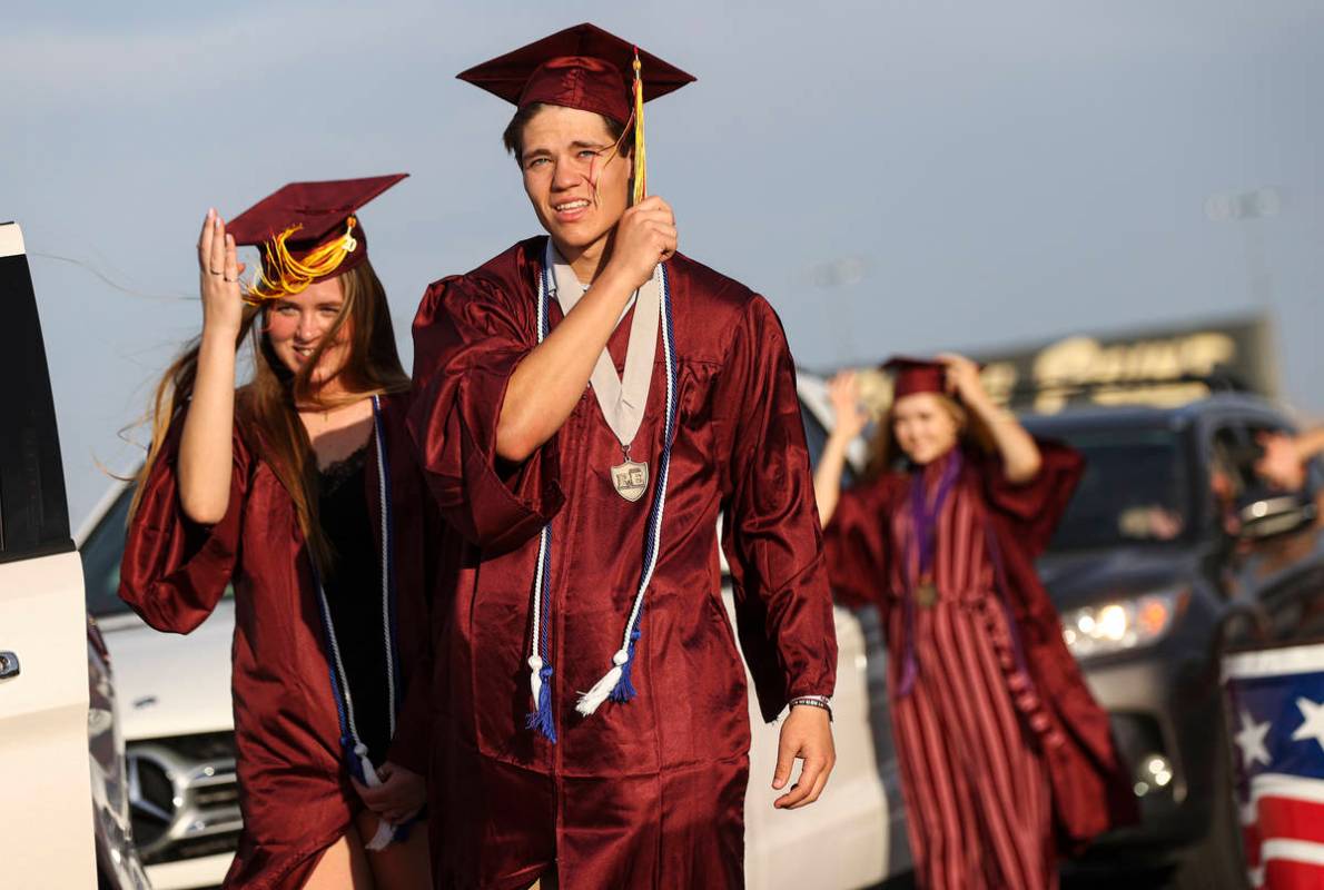 Faith Lutheran High School students Izzy Hyzak, left, and Zach Hyzak turn their tassels during ...