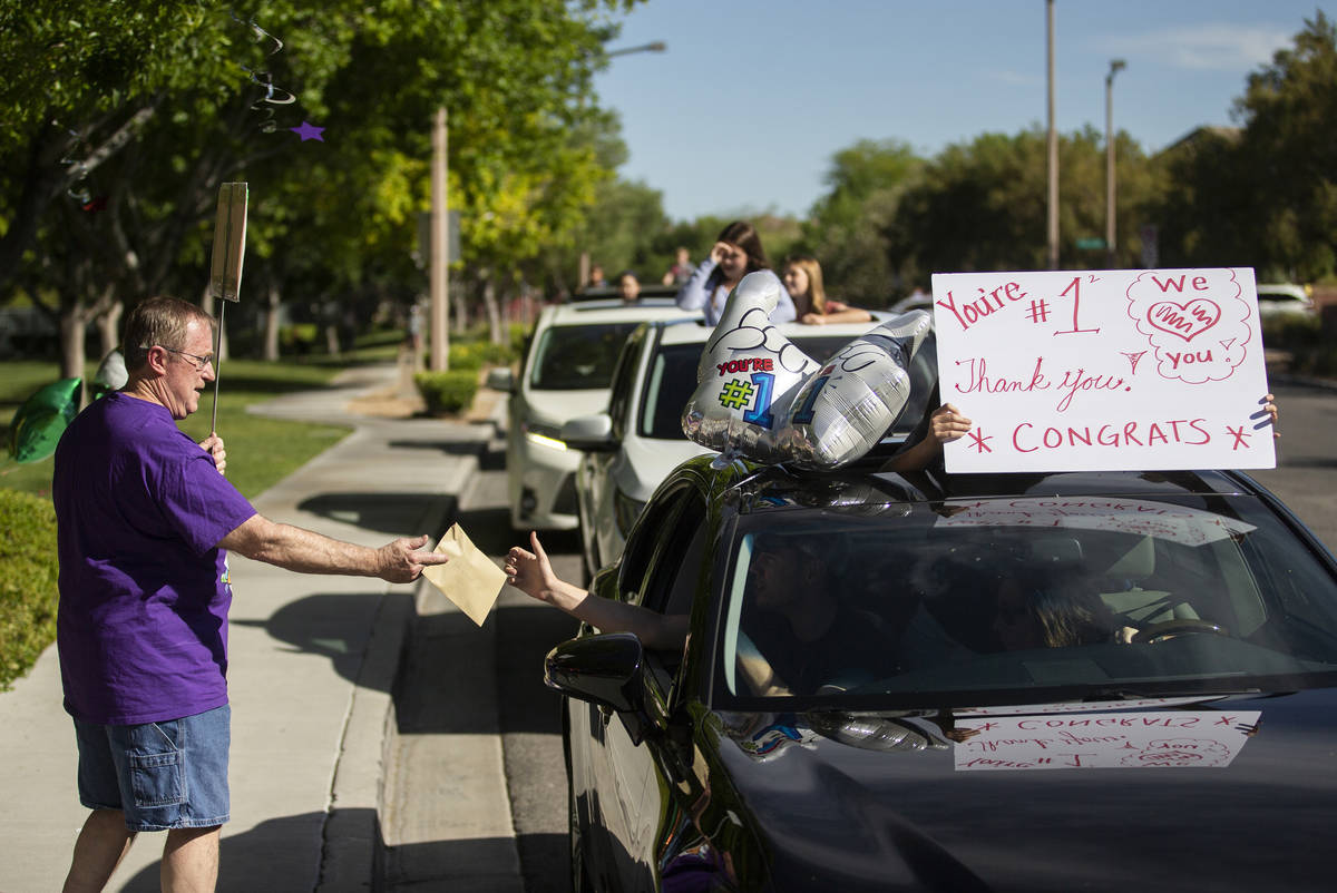 Gary Grosenick, left, a teacher at John & Judy Goolsby Elementary School, receives a card d ...