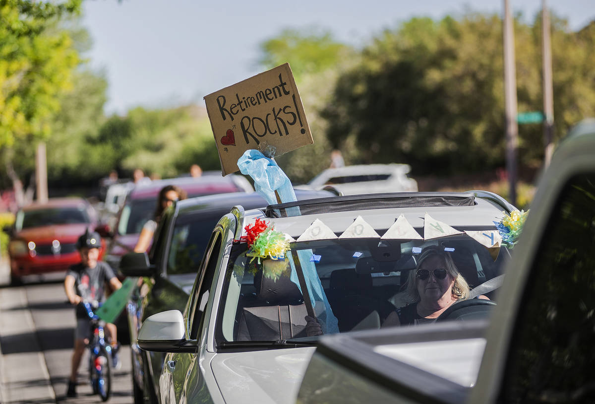 Signs sending well wishes can be seen from a line of cars during a “drive-by” re ...