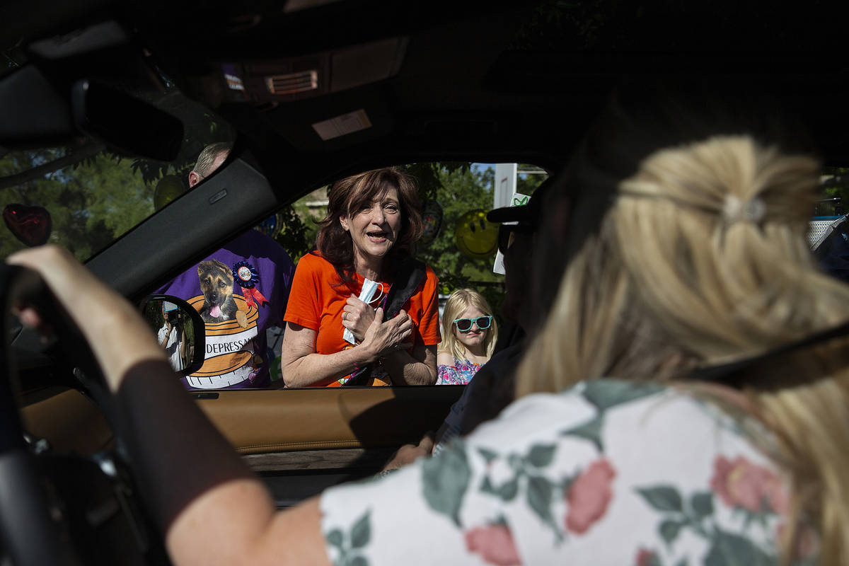 Laurie Grosenick, middle, a teacher at John & Judy Goolsby Elementary School, greets friend ...
