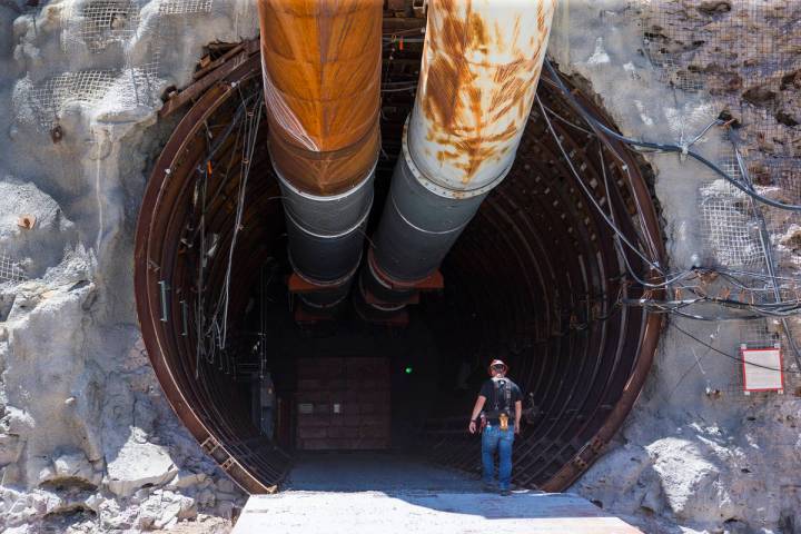 A contractor walks into the south portal of Yucca Mountain during a congressional tour near Mer ...