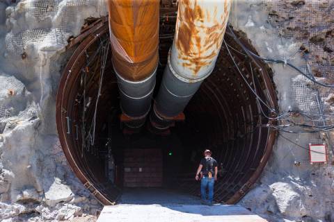A contractor walks into the south portal of Yucca Mountain during a congressional tour near Mer ...
