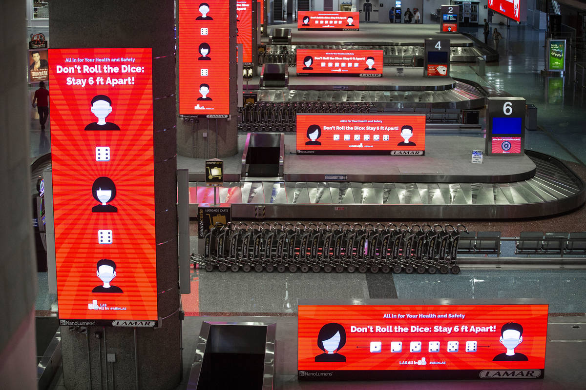 New signage outlining coronavirus safety guidelines in terminal one at McCarran International A ...