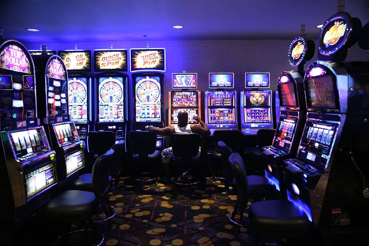 A man sits in front of a slot machine at the D Las Vegas in downtown Las Vegas, Aug. 23, 2019. ...