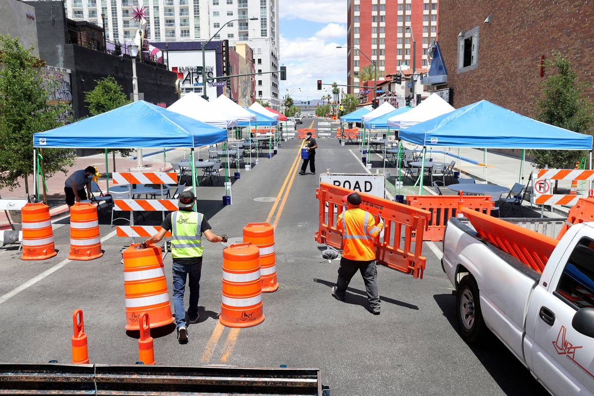 Eric Maldonado, left, and Ray Sandoval with of Work Zone Traffic Services, Inc. close 6th Stree ...