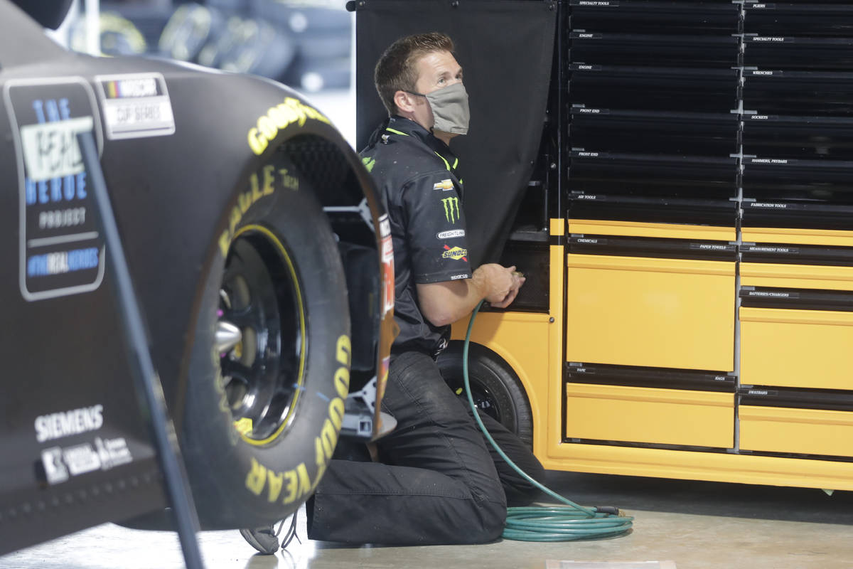 A crew member for driver Kurt Busch wears a mask as required for safety measures due to the cor ...