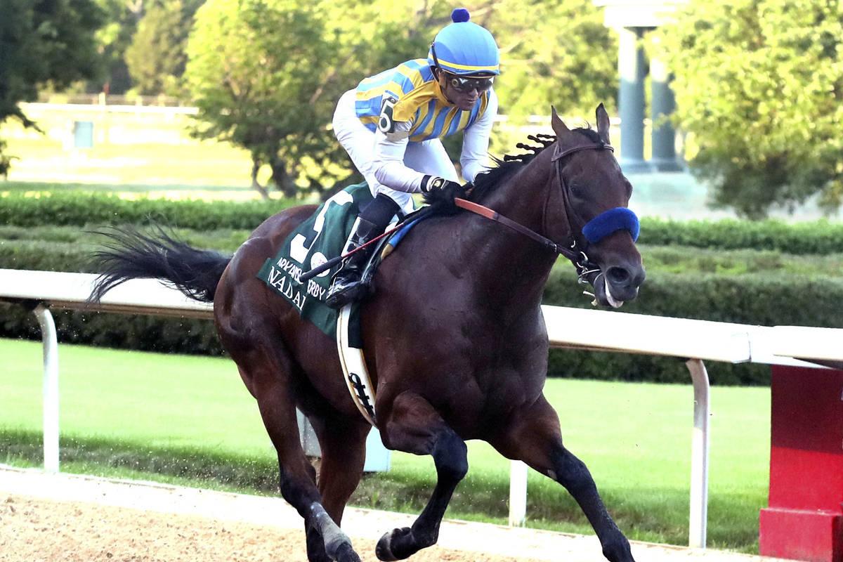 Joel Rosario, top, and Nadal cross the wire to win the second division of the Arkansas Derby ho ...