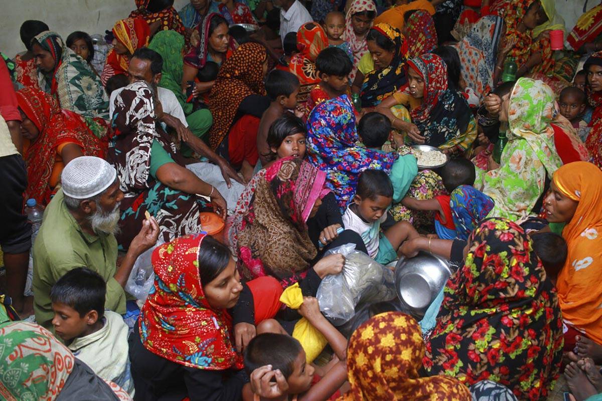 In this Wednesday, May 20, 2020 photo, people crowd a shelter before Cyclone Amphan made landfa ...