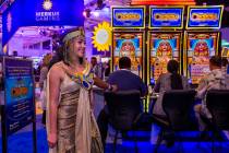 Cleopatra is on hand as attendees play games on display in the IGT exhibition space during the ...