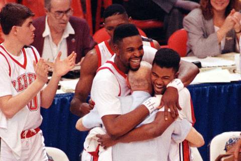 UNLV players Moses Scurry, left, and Anderson Hunt hug their coach Jerry Tarkanian after their ...