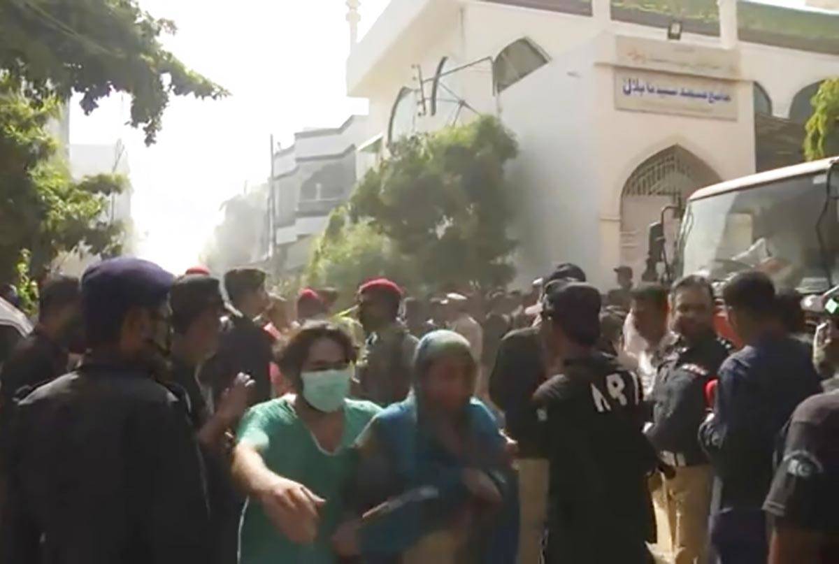 In this image made from video, crowds gather at scene of plane crash near Karachi, Friday, May ...