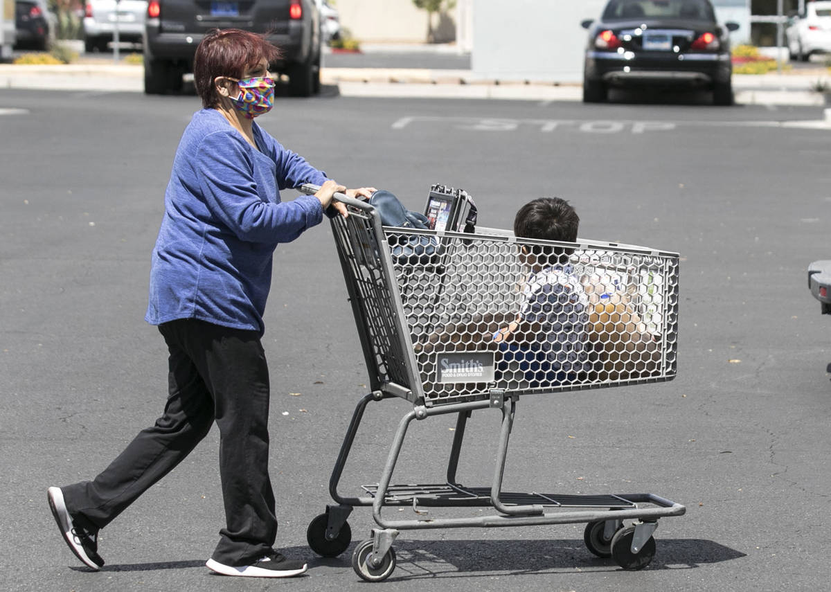 Lisha Valles, pushes her grandson, Phoenix Trejo, 3, in a grocery cart after shopping on Friday ...