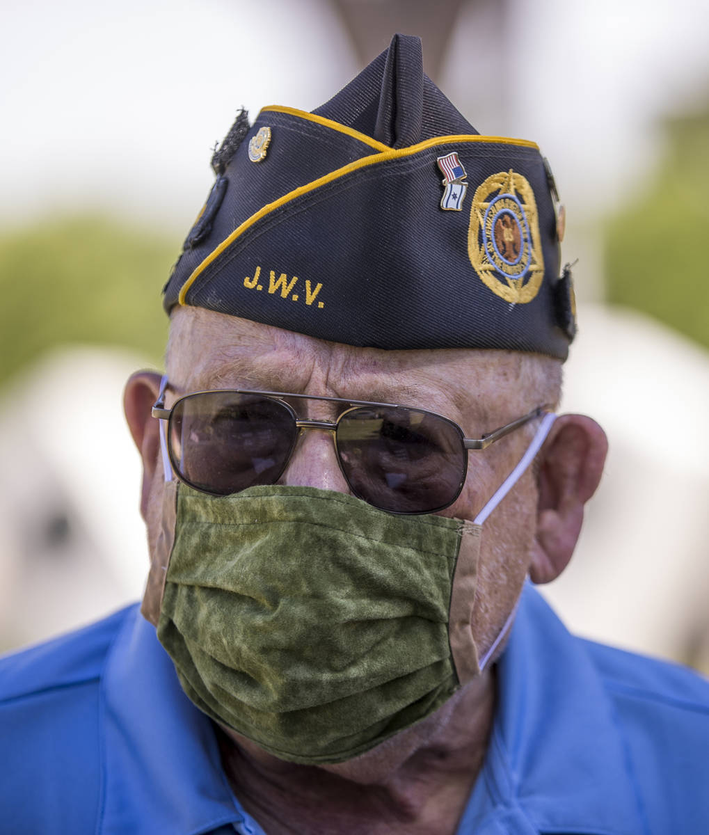 Retired Army Lt. Steve Seiden pauses while planting more American flags on veteran's graves in ...