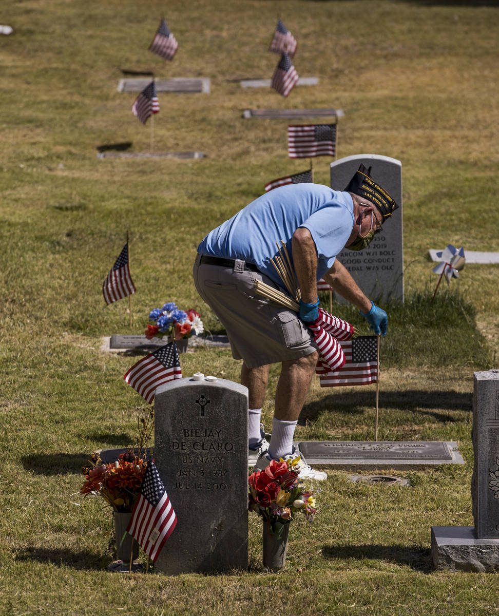 Retired Army Lt. Steve Seiden plants another American flag on veteran's graves in honor of Memo ...