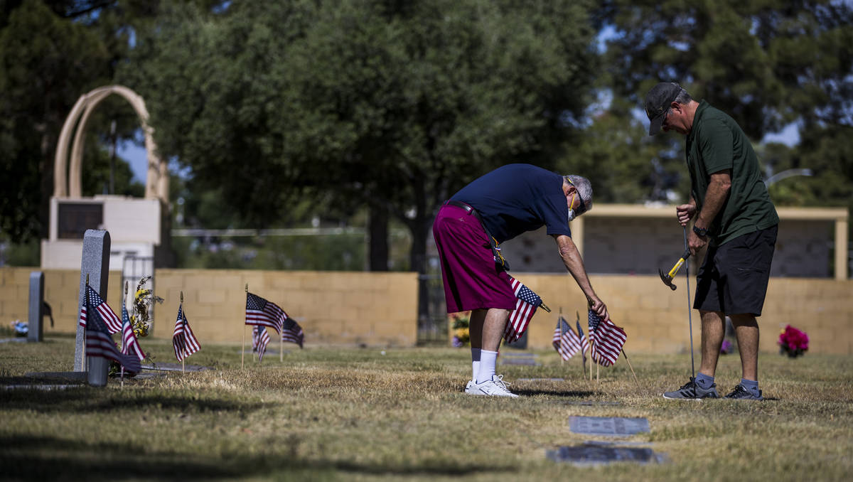 Mort Friedlander, left, and son Frank team up to plant more American flags on veteran's graves ...