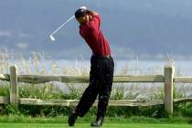FILE - In this June 18, 2000, file photo, Tiger Woods tees off on the 18th hole on his way to w ...