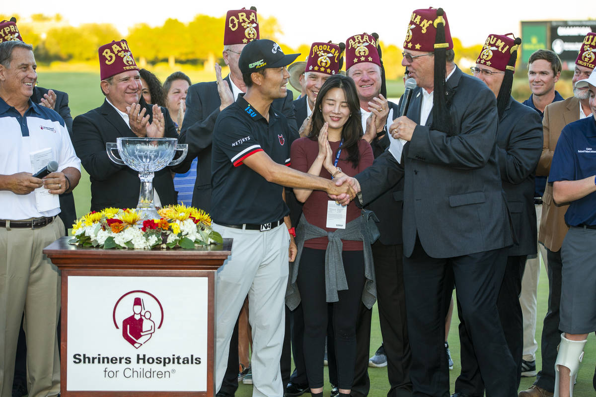 Kevin Na, center, shakes the hand of Imperial Potentate Jerry Gantt after winning the tournamen ...