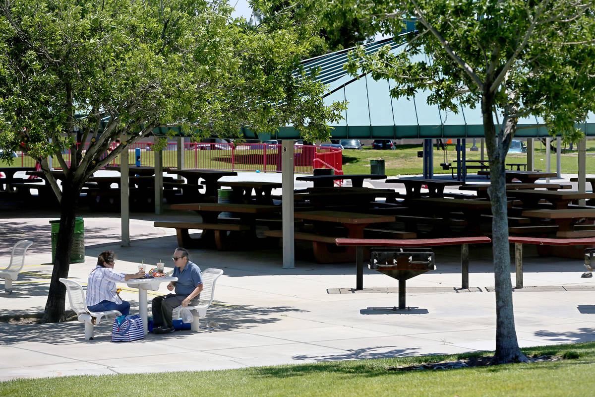People eat lunch at Mountain Crest Park in Las Vegas, Saturday, May 23, 2020. (Erik Verduzco / ...