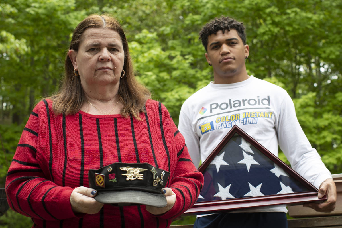 In this Friday, May 22, 2020, photo Florence Hopp, left, holds the hat her husband Robert Hopp ...