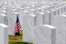 In a May 22, 2020, photo, a U.S. flag decorates a veteran's grave at Alabama National Cemetery ...