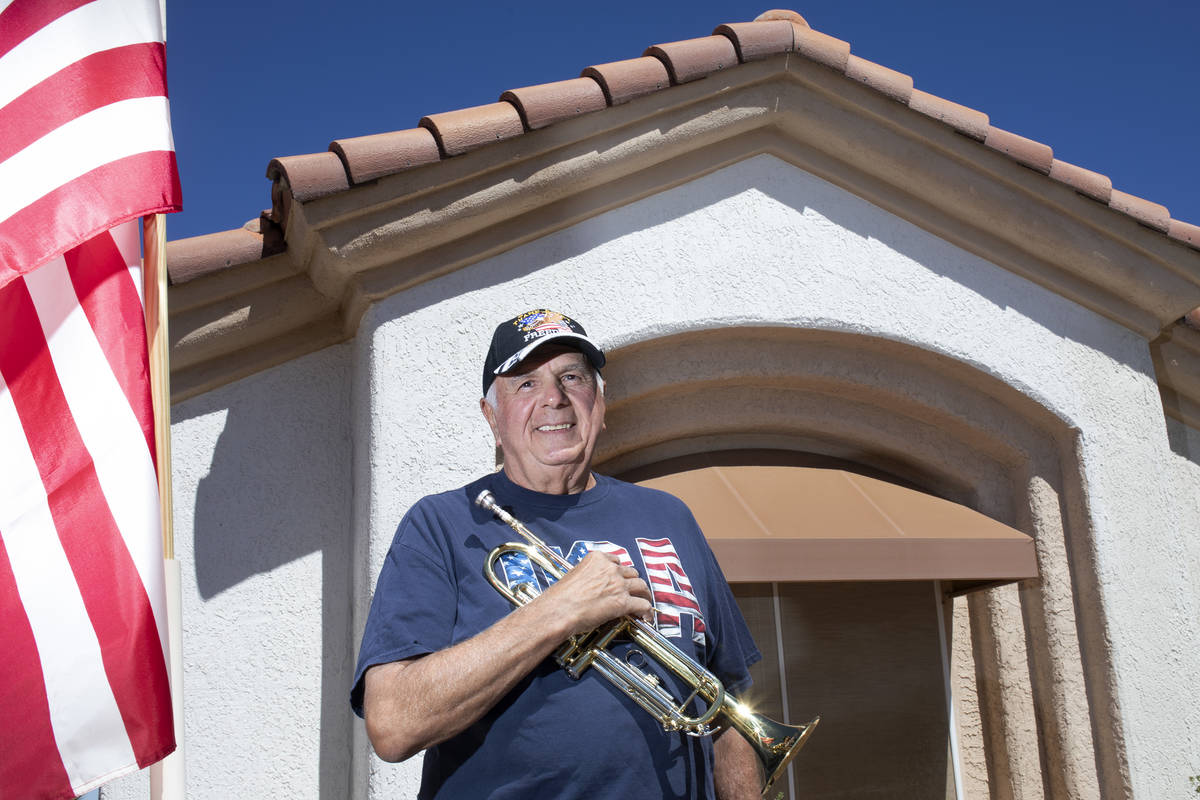 Bob Altomondo, who played trumpet in the Navy, poses for a photo before playing TAPS outside hi ...
