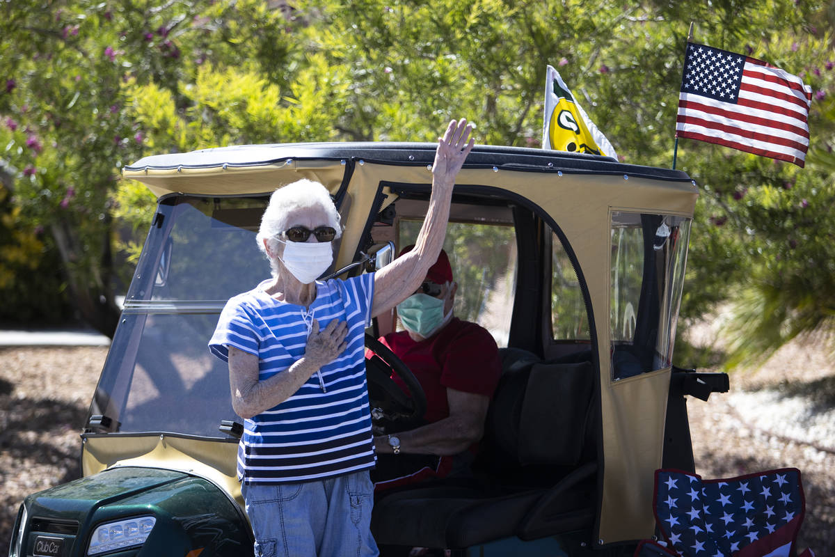 Marjorie McDain and her husband John McDain say the pledge of allegiance after listening to Bob ...