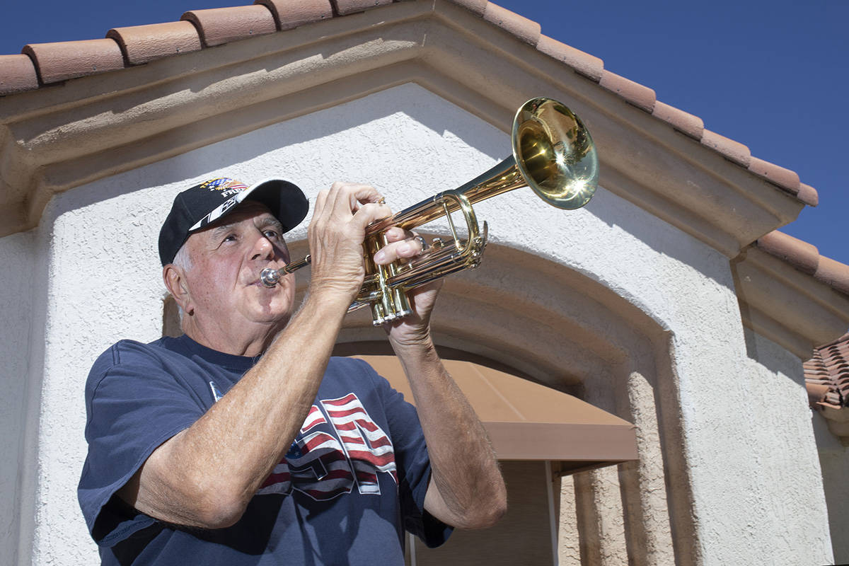 Bob Altomondo, who played trumpet in the Navy, poses for a photo before playing TAPS outside hi ...