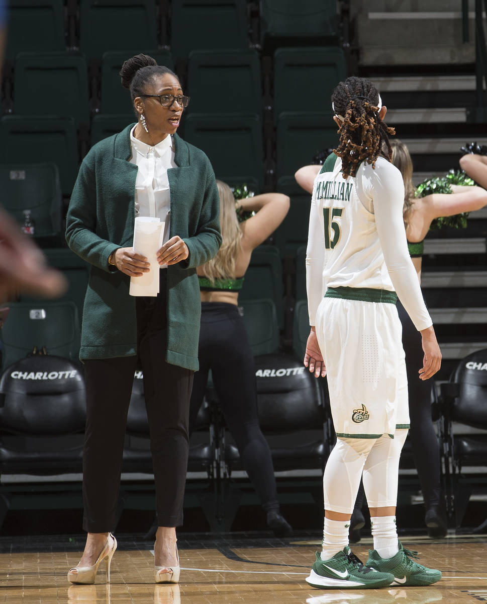 Charlotte women's basketball head coach Tanisha Wright talks with guard Jada McMillian. (Sam Ro ...