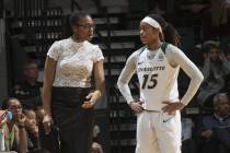 Charlotte women’s basketball head coach Tanisha Wright talks with guard Jada McMillian. (Sam ...