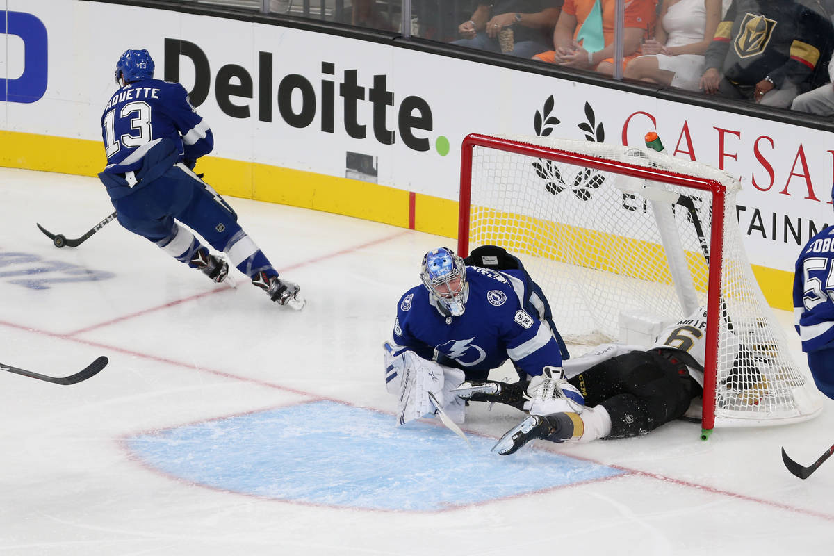 Vegas Golden Knights defenseman Colin Miller (6) crashes into the goal with Tampa Bay Lightning ...